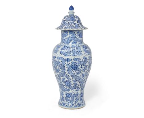 A Chinese blue and white moulded 'floral' baluster vase and coverQing dynasty, Kangxi periodThe baluster body with fluted sid