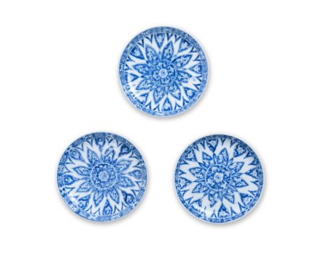 Three Chinese blue and white 'lotus' dishesQing dynasty, Kangxi periodEach decorated with a stylised lotus flower insider a b