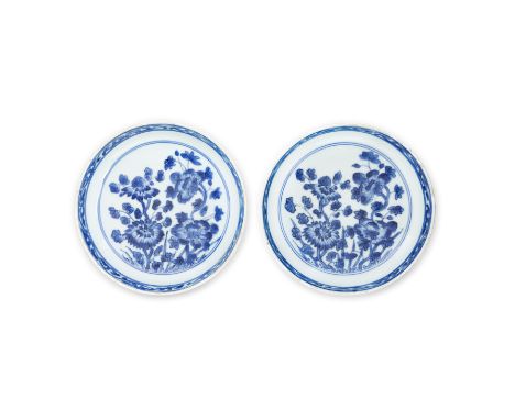 A pair of Chinese blue and white 'chrysanthemum and camellia' dishesQing dynasty, Kangxi periodThe shallow vessels standing o