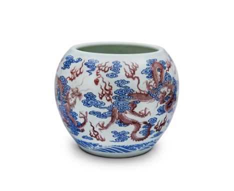 A large Chinese underglaze red and blue and white 'dragon' jardinière20th centuryPainted in the Kangxi style with four scaly 