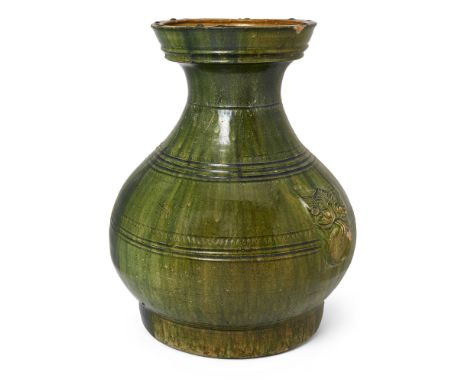 A large Chinese green-glazed jar, huHan dynastyWith flat base raised on three rectangular tripod feet, the compressed globula