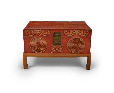 A Chinese red lacquered and gilt leather trunk on hongmu standLate Qing dynasty/Republic periodDecorated in relief and gilt t