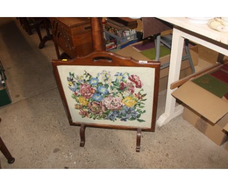 A mahogany framed embroidered fire screen