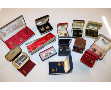 A box containing various cuff-links; cigarette lighter etc.