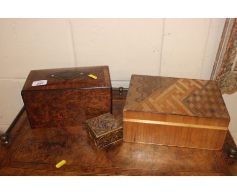 A Victorian walnut tea caddy; a straw work box; and a small gilt trinket box 