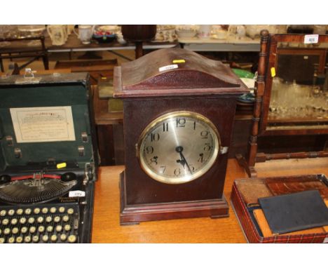 A mahogany cased chiming mantel clock