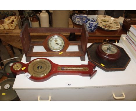 A vintage Smith alarm clock, a book rack, two barometers and a tray