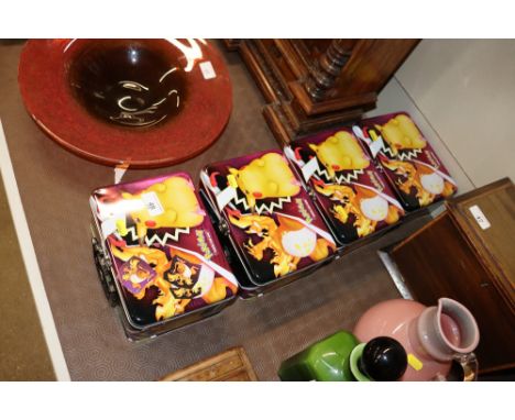 Four Pokémon tins and contents of cards, dice, counters etc.