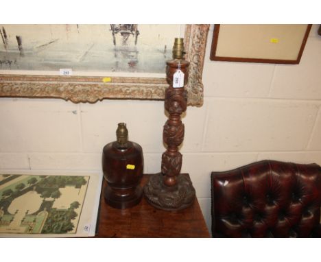 A carved Oriental table lamp with dragon decoration and a walnut baluster table lamp 