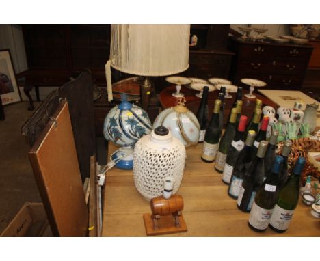 A large brass table lamp; an Oriental pottery table lamp with  pierced decoration and three others 