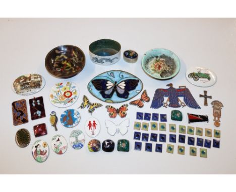 A collection of enamel decorated items including dishes, badges and plaques 