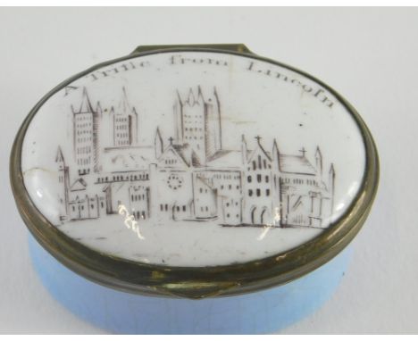 A Trifle from Lincoln enamel patch box, of oval form, with mirror to the lid, with Lincoln Cathedral to the exterior, 3cm hig