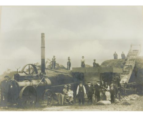 An early 20thC photograph, of a Lincolnshire field with a Caterpillar tractor, possibly Rustons, and farm hands, 15cm x 20cm,
