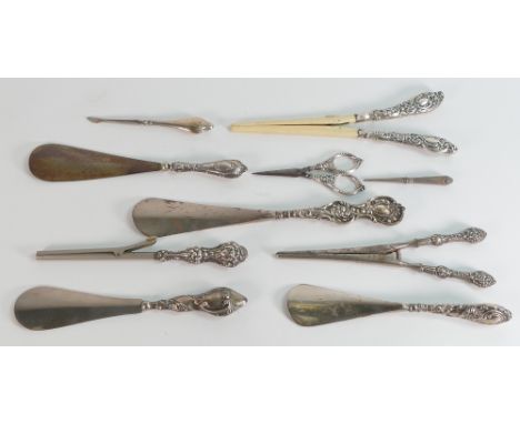 10 silver handled implements including 4 x shoe horns, 3 x tongs / stretchers, nail implement, scissors, and a broken item.  