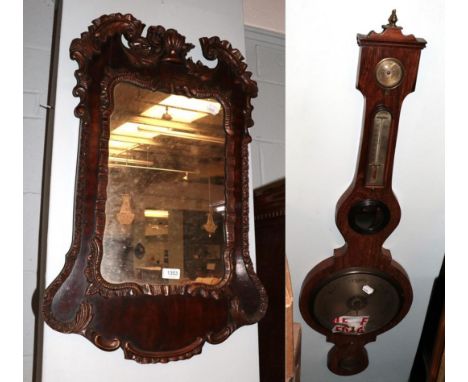 A mahogany wheel barometer circa 1840, spirit level dial signed Stanley, Boston; and a 20th century scroll decorated wooden f