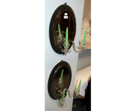 A pair of mirrored twin-light wall sconces 