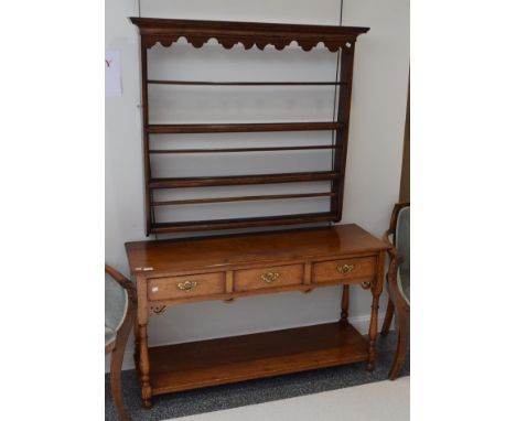 A reproduction oak three-drawer dresser base, with a pot board shelf, 126cm wide  