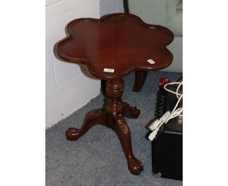 A reproduction carved tripod table 