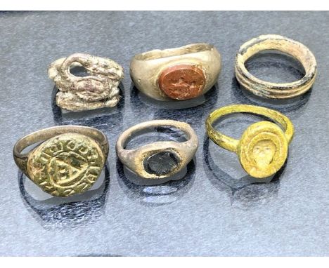 Collection of six rings of varying ages to include bronze signet ring, a marriage ring, a silver intaglio stamp ring, possibl