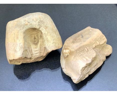 Two fragments of terracotta tile, possibly Egyptian in origin, one depicting the face of a pharaoh, one with hieroglyphics, b