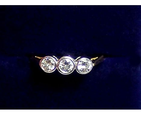 An 18ct white and yellow gold ring collet set three diamonds, size K, 2.2g 