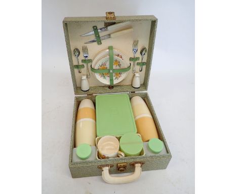 A 1950's Brexton picnic set with china daffodil pattern cups, saucers and cake plates, cutlery etc. completed boxed 