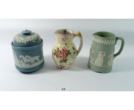 A stoneware tobacco jar applied hunting scenes, 14cm tall and two jugs