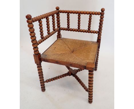 An Arts &amp; Crafts William Morris style bobbin turned corner chair with rush seat 