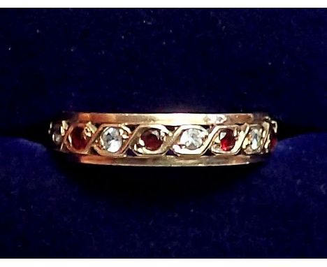 A 9 carat gold garnet and white stone eternity ring, size J to K, 2.2g 