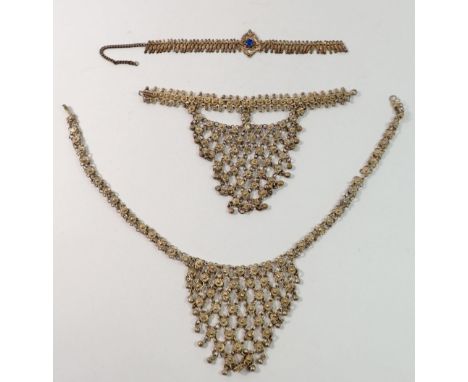 An Indian vintage white metal necklace and hand jewellery pendant plus another white metal necklace 