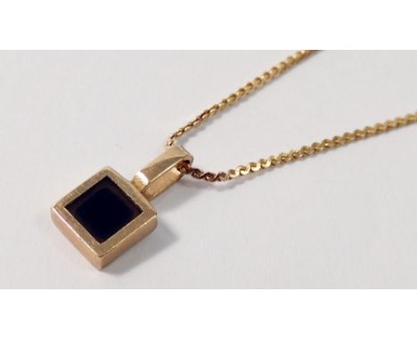 A yellow metal pendant on fine 9 carat gold chain 