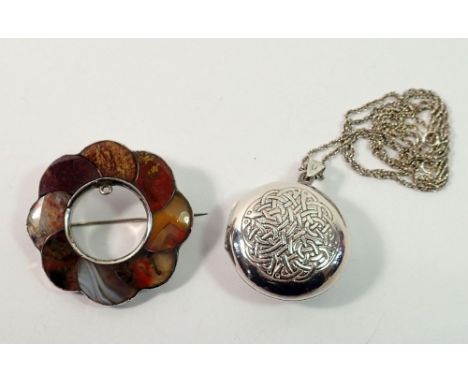 A silver Scottish stone set brooch and a silver Celtic style locket with text to verso and a silver chain 