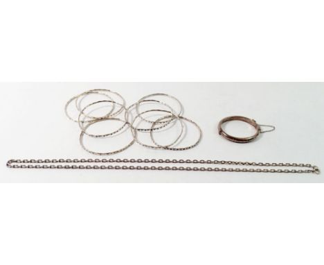 Eight white metal bangles 40g, a silver christening bracelet 8.3g and a silver chain 12g 