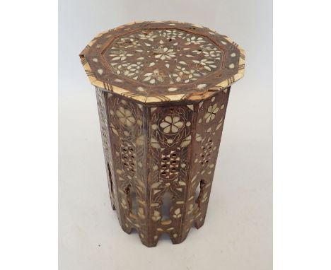 A Moroccan hardwood occasional table inlaid mother of pearl, 50cm tall, 32cm diameter 