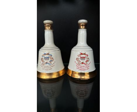 Pair of Bells Scotch Whisky commemorative porcelain decanters celebrating the births of Prince William (1982) and Prince Henr