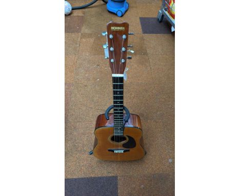Hohner acoustic guitar with a rich wood finish, six strings, and chrome tuners. Classic design