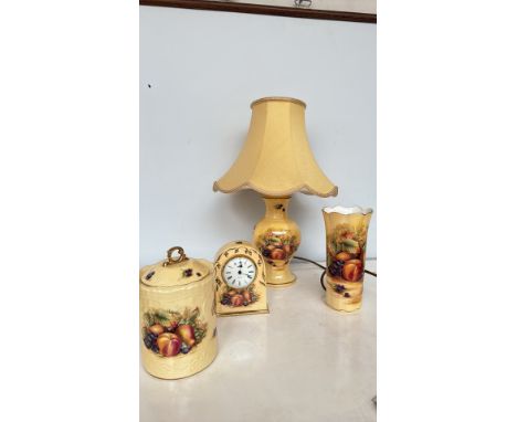 Aynsley "Orchard Gold" fine bone china decorative lot includes a lamp, mantel clock, vase, and lidded jar. Each piece feature