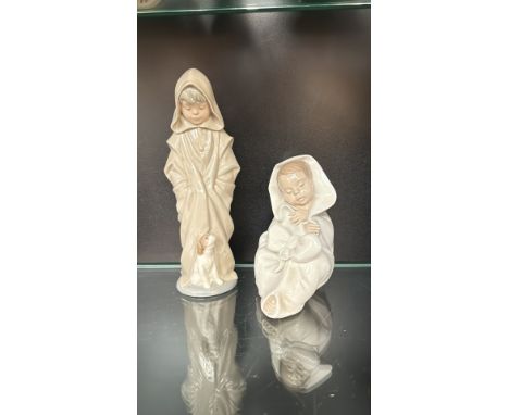 Pair of Nao by Lladró porcelain figurines made in Spain in 1982, consisting of glazed ceramic depicting robed children, one w