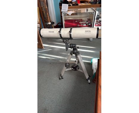 Meade Digital Electronic AutoLocator telescope includes a tripod and features an adjustable mount.