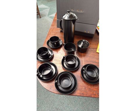 Wedgwood Black Basalt coffee set, including cups, saucers, creamer, sugar bowl, and tall coffee pot. Made of matte black ston