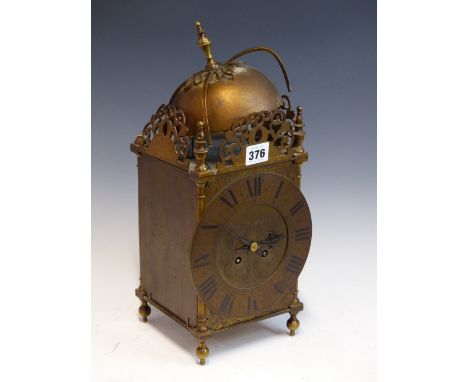 A LANTERN CLOCK, THE MOVEMENT WITH A PLATFORM ESCAPEMENT AND STRIKING ON A BELL.   H 38cms.