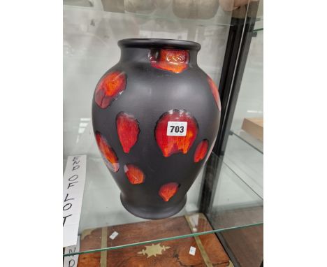 A POOLE POTTERY RED SPLASHED BLACK GROUND VASE