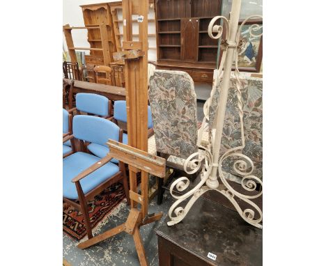AN ARTIST EASEL AND AN IRON LAMP STAND. 