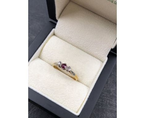 A RUBY AND DIAMOND THREE STONE RING. THE RING UNHALLMARKED, STAMPED 18ct AND PLAT, ASSESSED AS 18ct GOLD AND PLATINUM. FINGER