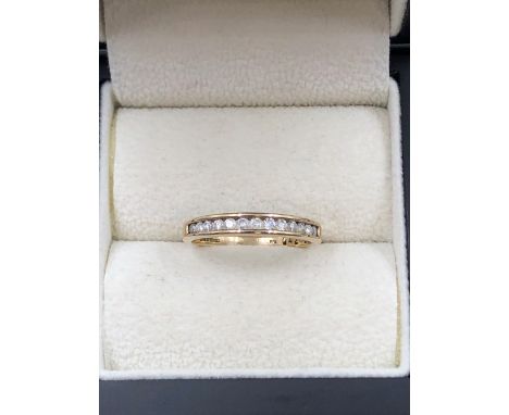 A 9ct HALLMARKED GOLD CHANNEL SET DIAMOND RING. FINGER SIZE P. WEIGHT 2.26grms. 