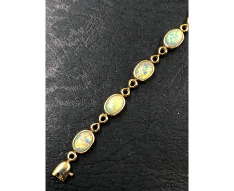 A 9ct HALLMARKED GOLD OPAL BRACELET. THE TWELVE OPALS EACH IN RUBOVER SETTINGS. BRACELET LENGTH 20cms. WEIGHT 10.12grms.