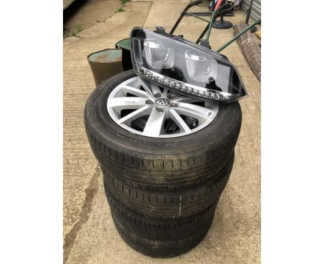 A SET OF FOUR VW POLO ALLOY WHEELS TOGETHER WITH A PAIR OF AS NEW VW POLO HEAD LAMP UNITS