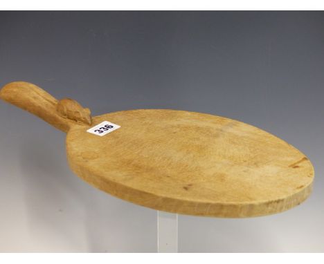 A ROBERT MOUSEMAN THOMPSON OAK OVAL CHEESE BOARD WITH A MOUSE CARVED TO ONE END OF THE HANDLE.   W 37.5cms.