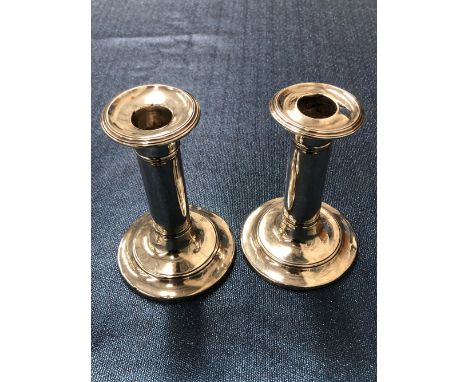 A PAIR OF VINTAGE HALLMARKED SILVER LOADED CANDLESTICKS.