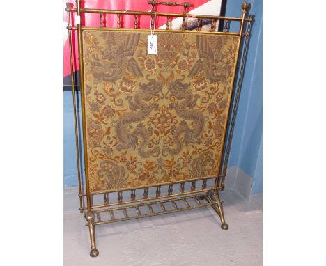 A VICTORIAN BRASS FIRESCREEN WITH A RECTANGULAR SILVER THREAD DAMASK INSET FEATURING DRAGONS AND PHOENIX